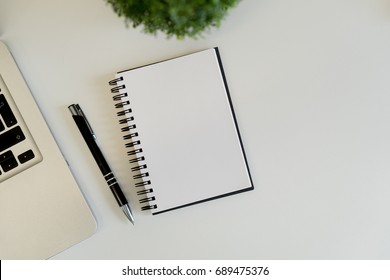 Office workplace with text space ,White table with office supplies smartphone,laptop,tablet and earphone, top view - Shutterstock ID 689475376