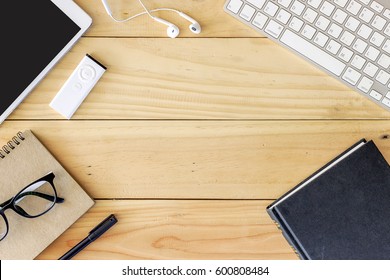 Office workplace with text space, Wooden table with office supplies tablet, desktop computer and book, top view, over light - Powered by Shutterstock