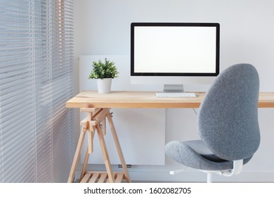 office workspace interior, computer on wooden table scandinavian style design, empty workplace, pc with blank screen - Powered by Shutterstock