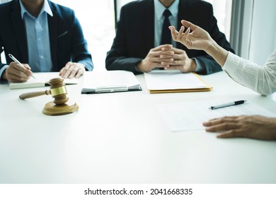 An Officer Or Client Use Her Hand  Presenting The Case To The Legal Team To Plan The Business.