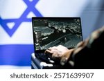 Officer in command center responsible for Israel air defense relaying instructions to squadrons patrolling over borders. Military intelligence agency spy using laptop software to do monitoring