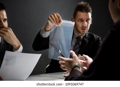 Officer In Interrogation Room Showing A Knife As A Murder Evidence, Crime Investigation And Criminalistics Concepts