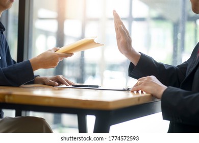 The officer refused to accept the money bribe envelope from the businessman the concept anti bribe or corruption - Shutterstock ID 1774572593