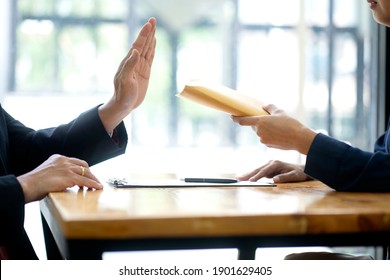 The officer refused to accept the money bribe envelope from the businessman the concept anti bribe or corruption - Shutterstock ID 1901629405