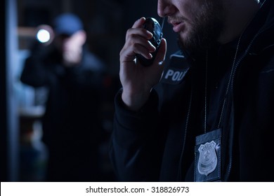 Officer Using Walkie Talkie During Police Intervention