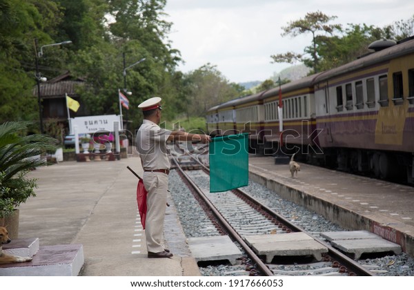 The officer waved the flag to
signal the train.at Lampang station in Thailand, 0n 29 April
2018.