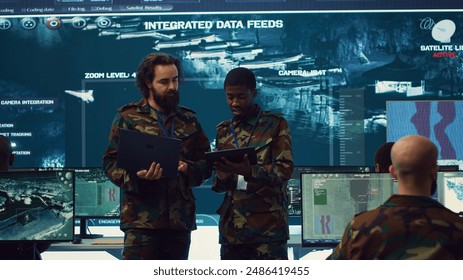 Officers team managing air traffic control for military aircrafts within the operational area, using CCTV radar surveillance. Evaluating and presenting mission plans to their crew. Camera A. - Powered by Shutterstock