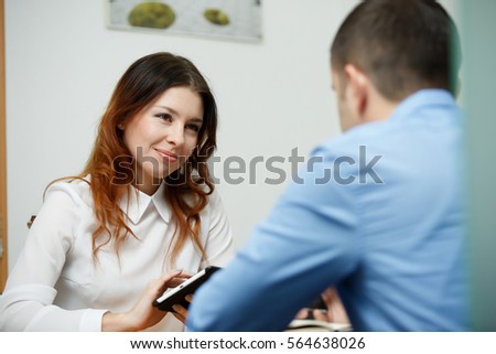 Officeworkers discuss topic with tablet