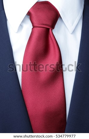 official dress code - classic blue suit, red tie knot, white shirt, closeup, official wear detail, 