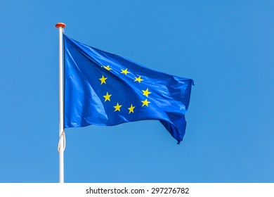 Official flag of the European Union in front of a clear blue sky