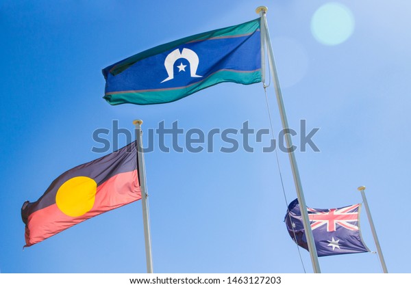 Official flags of Australia: the\
Australian flag, Aboriginal flag and Torres Strait Islander\
flag