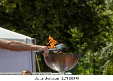 Official Lighting Of The Torch At A Sporting Event