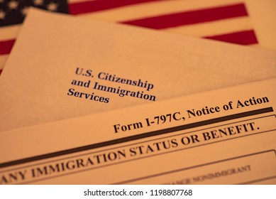  Official USCIS Envelope Next To Form I - 797C (Notice Of Action, Immigration Status) And Flag Of USA. 