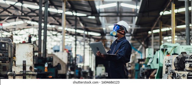 Officials from the Department of Hazardous substances control bureau is investigating the leak of a hazardous chemical in a chemical plant. Man with protective mask and computer laptops in factory - Shutterstock ID 1604686123