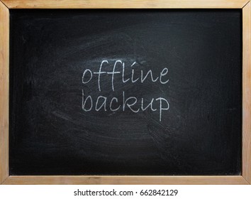 Offline Backup text written on black school board with wooden frame.
