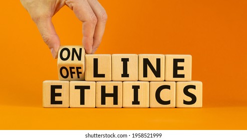 From offline to online ethics. Businessman turns a cube and changes the words 'offline ethics' to 'online ethics'. Beautiful orange background. Copy space. Business, online ethics concept.