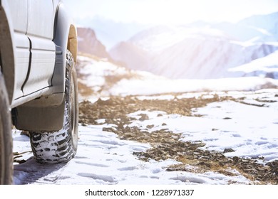 Offroad 4x4 Car Wheel On Snow Surface. Winter Tires Concept