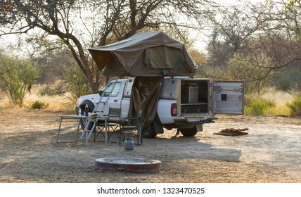 Offroad 4x4 Vehicle With Tent In The Roof Ready For Camping In The Desert