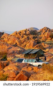 Offroad 4x4 Vehicle With Tent In The Roof Ready For Camping In The Desert