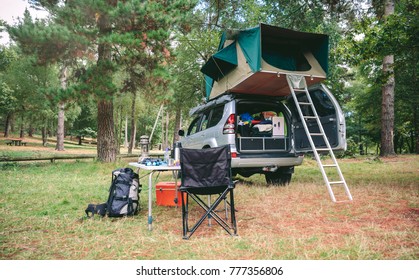 Offroad 4x4 Vehicle With Tent In The Roof Ready For Camping In The Forest