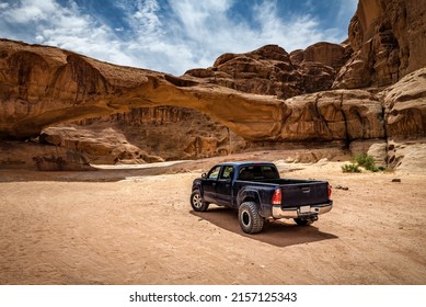 Off-road car near the rock arch in Wadi Rum desert. Jordan - Shutterstock ID 2157125343