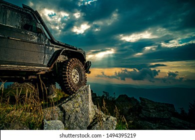 Offroad Car On Mountain Road. Shock Absorber For Off Road Car. Car Brakes With Absorbers. Car Tire. Tire For Offroad