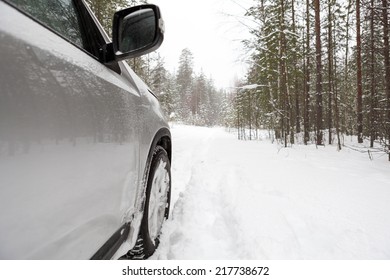 Offroad car standing on snowy forest road, copyspace