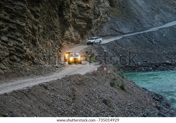 Off-road cars riding mountain serpentine in the\
Pamir mountains