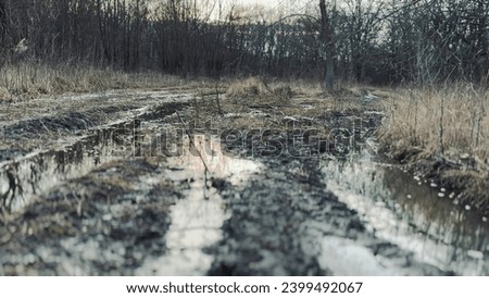 off-road. muddy way in the forest early spring just melted the snow. road dirt water puddles off-road in the forest. xtreme path forest no road water lifestyle mud puddles