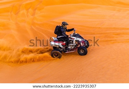 Offroad safari in sand desert, Empty Quarter Desert in United Arab Emirates. Quad bike on sand dune in Rub’ al Khali desert in sunset time.