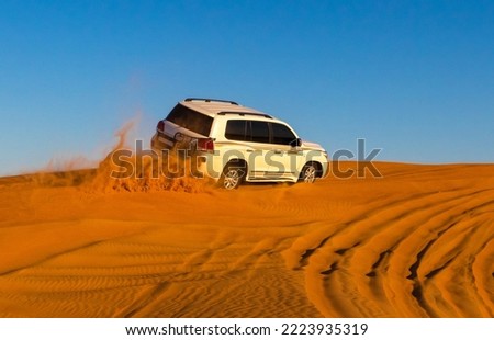 Offroad safari in sand desert, Empty Quarter Desert in United Arab Emirates. Offroader on dunes in Rub’ al Khali desert. Sand and sky.