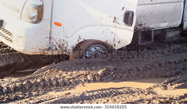 Off-road truck\
settles down in mud on dirty\
road\
