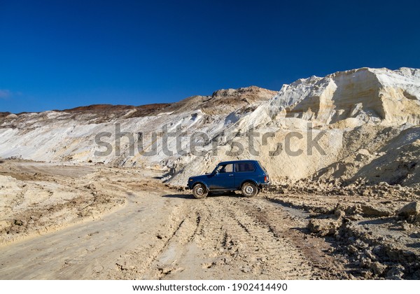 Off-road vehicle in a clay quarry\
on a winter day. Zaporozhye region, Ukraine. January\
2015