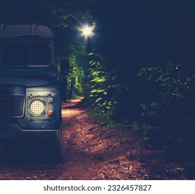 An Off-Road Vehicle Driving A Forest Trail At Night With Copy Space - Powered by Shutterstock