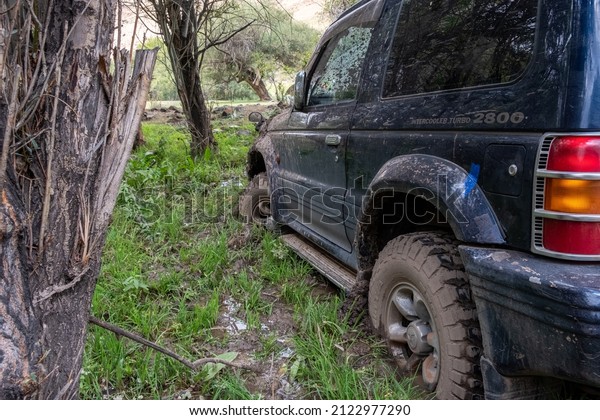 Off-road\
vehicle Mitsubishi pajero stuck in the mud. Dirty offroad car in\
swamp. Adventure travel concept. 4x4 SUV got bogged. Journey,\
tourism concept. 10.08.2021 Almaty,\
Kazakhstan.