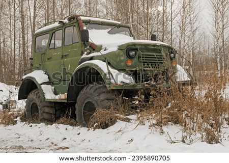 off-road vehicle on big wheels in the winter forest