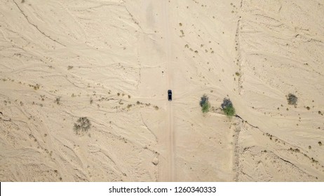 Off-road vehicle on a desert road - Aerial image