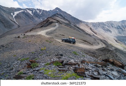 Off-road vehicle on the road to mountain pass