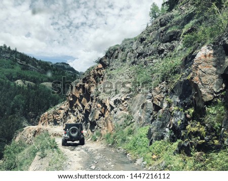 Off-roading in a Jeep on a cliff side.