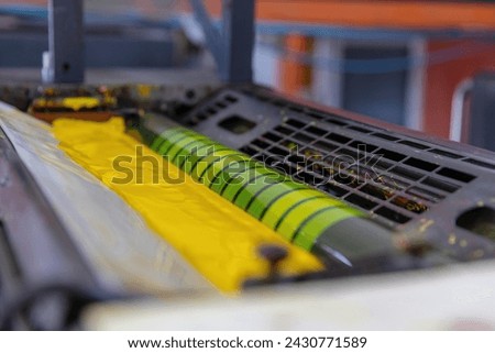 Offset  machines. Large printing machine perspective. printing machine cylinders and printing ink pot. Offset machine. Offset press is a printing machine designed to produce fine quality 