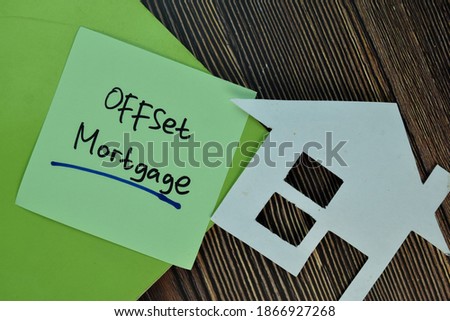 Offset Mortgage write on sticky notes isolated on Wooden Table.