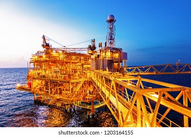 Offshore Construction Platform For Production Oil And Gas With Bridge In Evening Time For Industrial Business Concept.