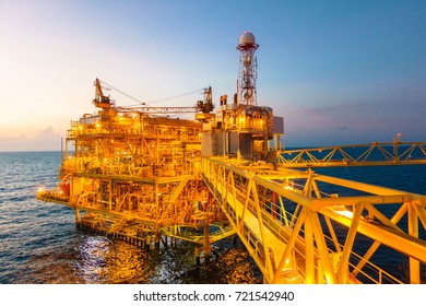 Offshore Construction Platform For Production Oil And Gas With Bridge In Evening Time For Industrial Business Concept.