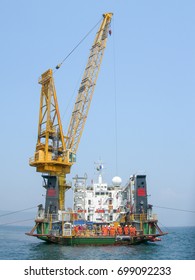 Offshore Construction Vessel Working On Subsea Infrastructure With Large Crane And Divers