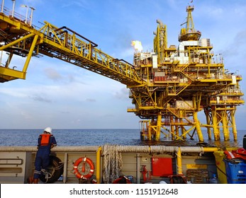 A Offshore Crew Looking At Oil And Gas Platform With Bridge For Petroleum Process And Production