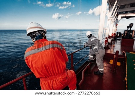 Offshore Deck Crew Performing Crane Operation on Supply Vessel at Sea
