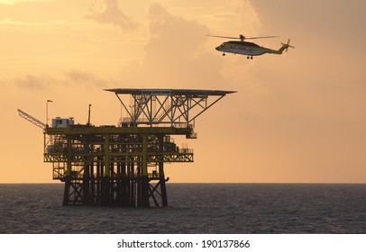 An offshore helicopter for transporting roughnecks approaches a rig
