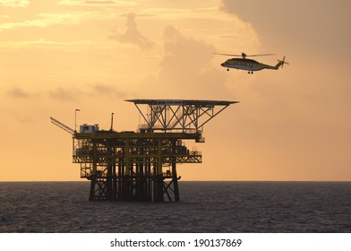 An offshore helicopter for transporting roughnecks approaches a rig