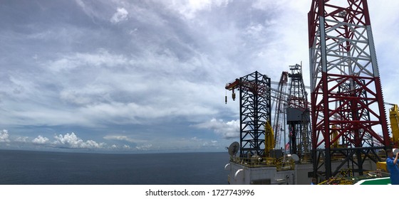 Offshore jack up crane tower tender rig or barge or Derrick of Tender Assisted Drilling Oil Rig (Barge Oil Rig) on The Production Platform During cloudy sky. jack up rig floating exploration. panorama