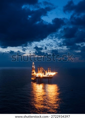 Offshore jack up rig in aerial view in the middle of the ocean taken by a drone